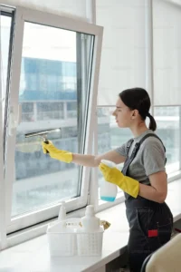 Expert performing window & floor cleaning service for residential space